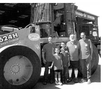 Three generations of the family in front of an SCD loader