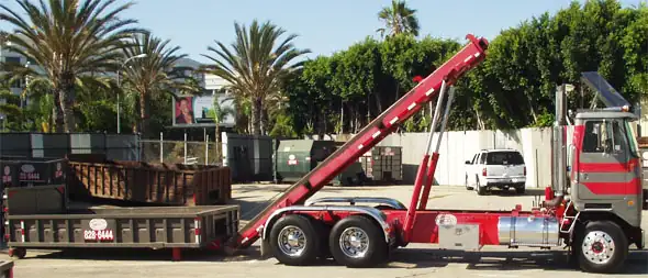 An SCD roll-off truck loading a container